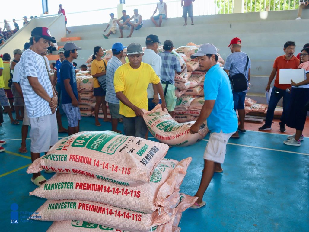 Farmer beneficiaries receive fertilizers, seeds, water pumps, and hose as assistance funded under the RA 7171 share of the town.