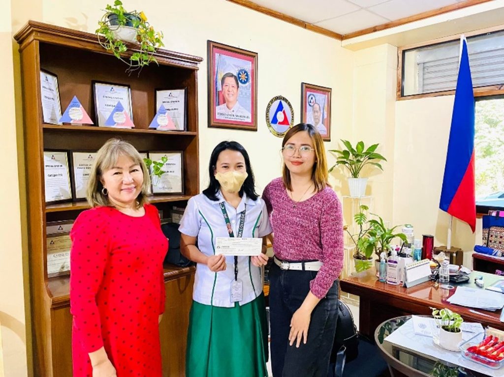 Workers Organization Development Program scholar Abelyn B. Obatay (center) received P17,500 worth of stipend for her second semester ScY 2022-2023 school expenses under the program from Department of Labor and Employment-10 Camiguin Provincial Field Office Chief Arlyn Z. Bael (left) and Labor and Employment Officer III and WODP Focal Person Jovelyn V. Perez (right). (Photo courtesy of DOLE-10 Camiguin PFO)