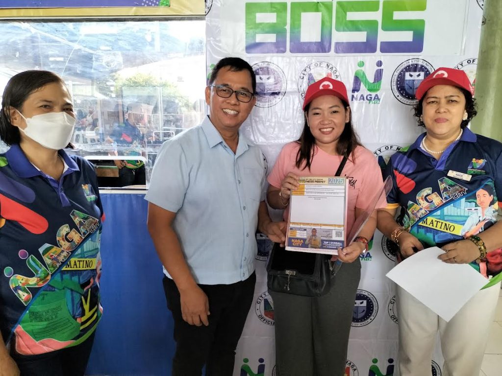 Claire Camacho Aliniante (2nd from right), owner of Nethlaine Aesthetic and Wellness Clinic located in Brgy. San Felipe, Naga City was the first taxpayer to finish the process and secure her Mayor’s Permit on the opening of BOSS 2025. She received a souvenir cap, as a token from Mayor Nelson Legacion (3rd from right) and City Treasurer Maricor Gayonilo (right). (JRM-PIA5/Camarines Sur)