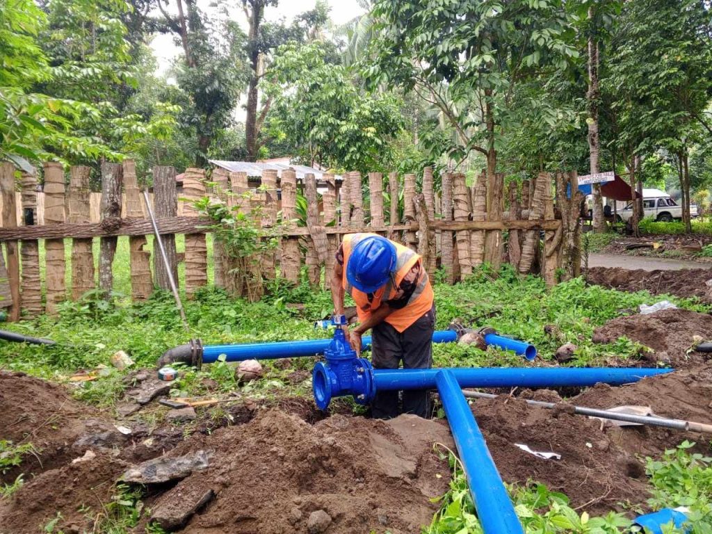 A personnel from Camiguin Water Company facilitates the mainline pipe reroute connection at Lower Cogon, Agoho, Mambajao. (Photo courtesy of CWC)