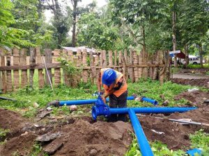A personnel from Camiguin Water Company facilitates the mainline pipe reroute connection at Lower Cogon, Agoho, Mambajao. (Photo courtesy of CWC)