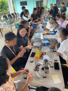 Participants engage in candle-making, applying techniques learned during the demonstration to create the aromatherapy candles. (Photo courtesy of DOST Camiguin)