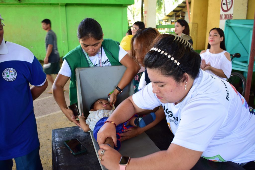 In this undated photo, healthcare workers measure the height of a child in Masbate City. Data showed that in 2019, Bicol had a level of stunting that exceeded 40 percent of the population of children below the age of five. (MCG pic)