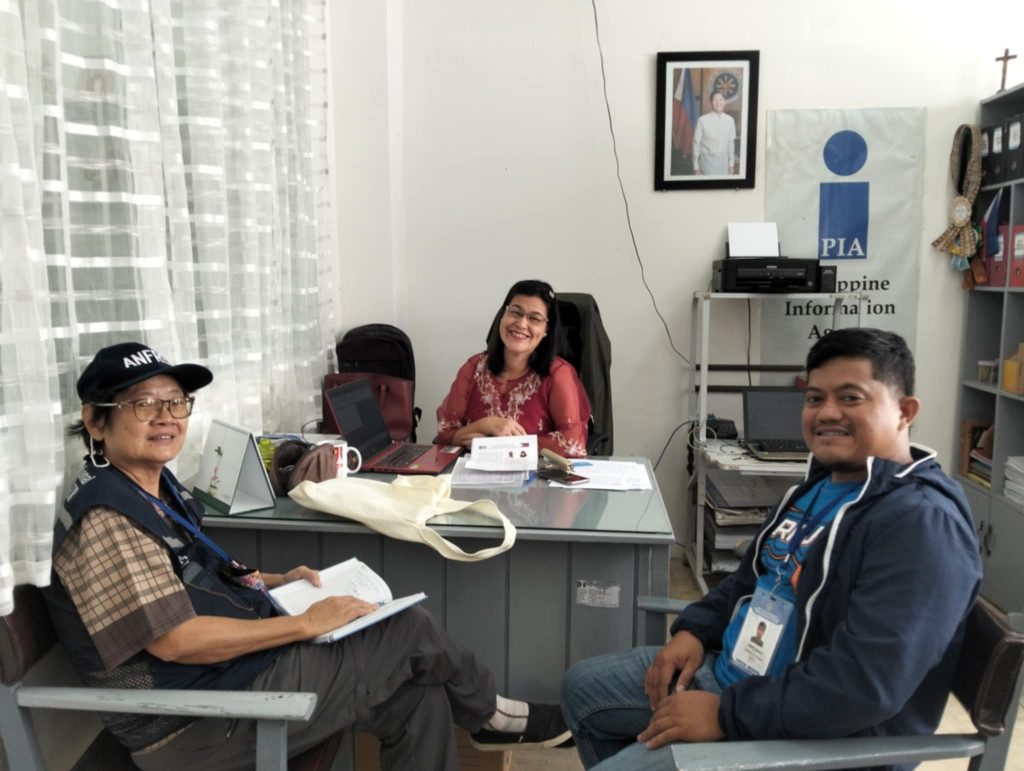 ANFREL observer from Thailand Laddawan Tantivitayapitak (left) together with Filipino counterpart, Huberto Senosin, Jr. visit PIA Sorsogon Information Center for an International Election Observation Mission (IEOM) to the 2025 Philippine National and Local Elections exchanging insights with PIA Infocen Manager Benilda Recebido. (Photo: PIA Sorsogon)